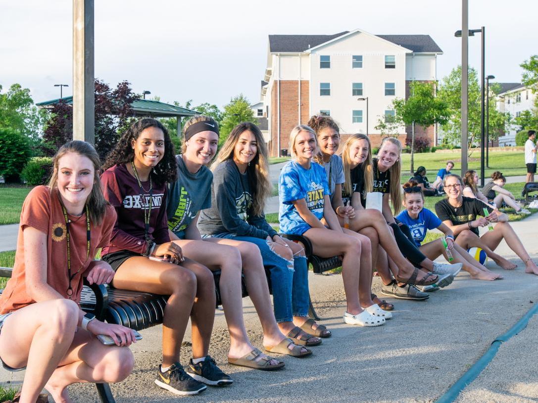 PFW students watching sand volleyball on the Student Housing campus.